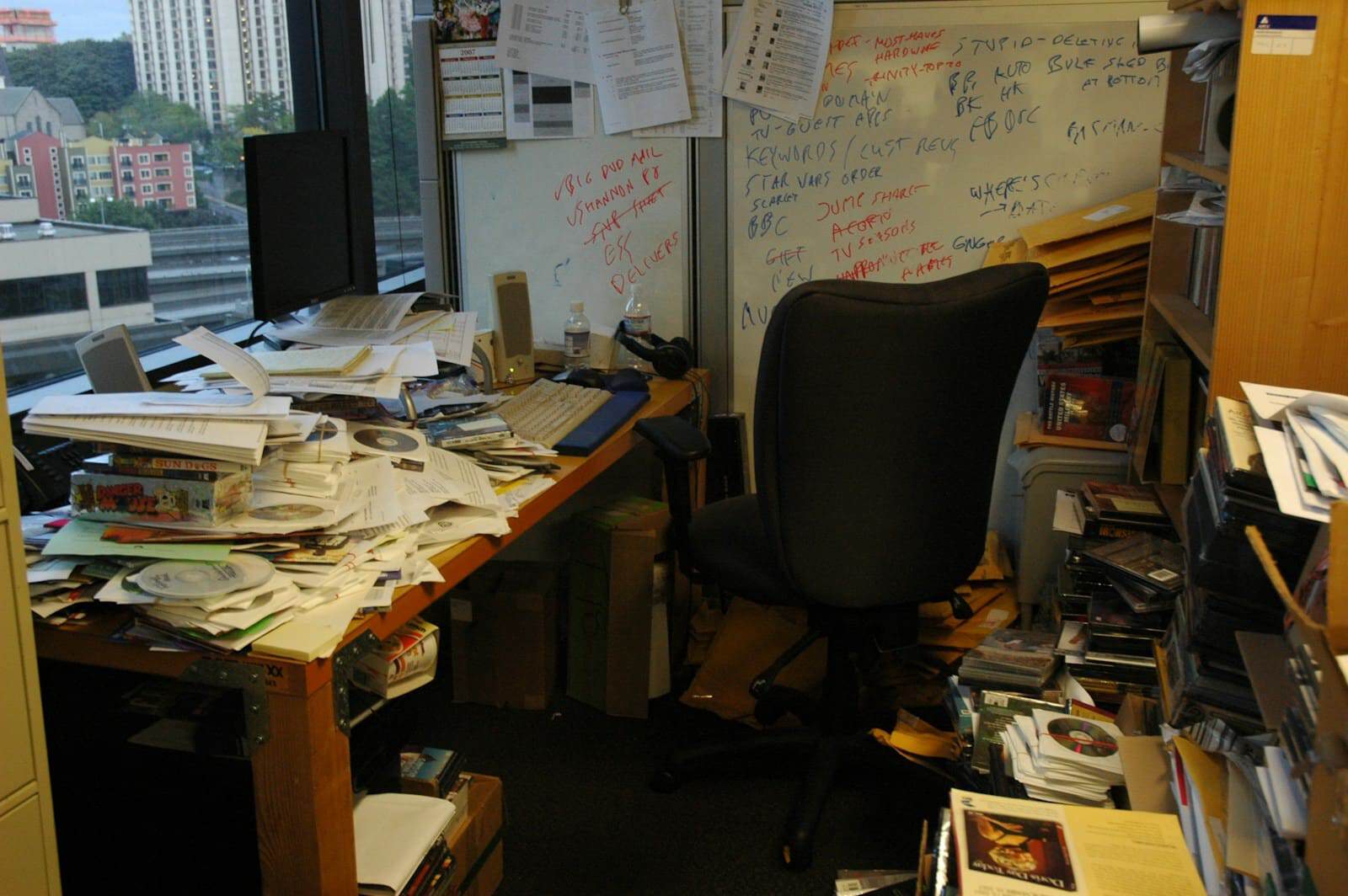 Alt text: Messy office space with papers, books, and clutter needing professional junk removal.